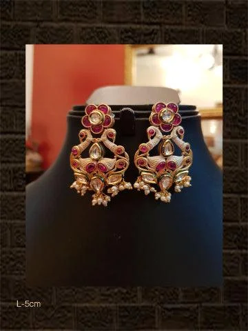 nature-themed ridge peak earrings-Ivory finish kundan earrings with ruby flower